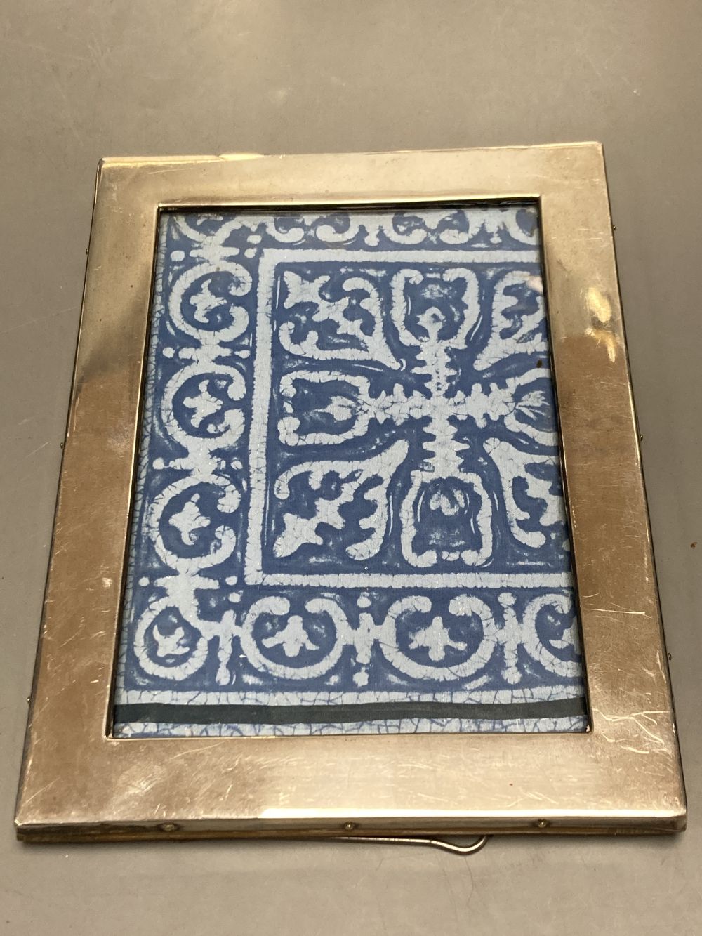 An Edwardian silver mounted photograph frame, Birmingham, 1906, 22.2cm(a.f.) and two others.